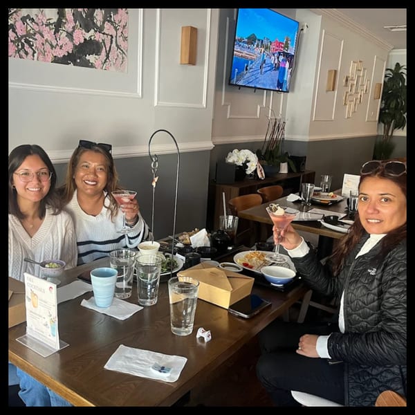 Three women enjoying cocktails and Japanese food at a table in Ko Japanese Dining.